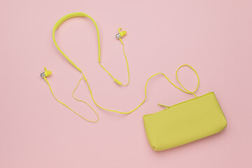 Wireless Yellow Earphones with Matching Pouch on Pink Background - Minimalist Flat Lay