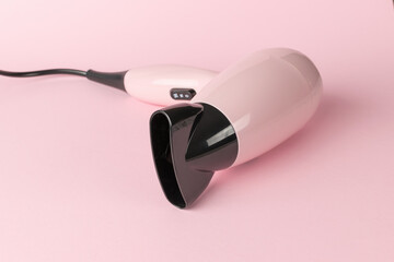Modern Pink Hair Dryer on Pastel Background - Stylish Beauty Appliance for Hair Care