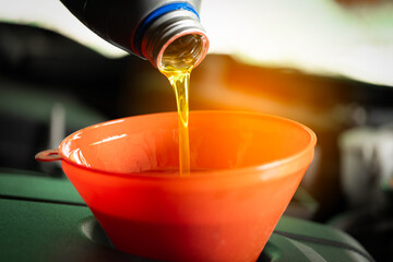 Refueling and pouring oil quality into the engine motor car Transmission and Maintenance Gear...