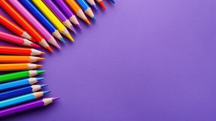 Colorful pencils on purple background for back to school theme Top view with copy space