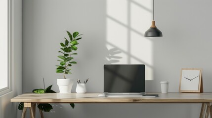 Obraz premium A clean and modern workspace with a laptop, a plant, and a wooden desk in a white room.
