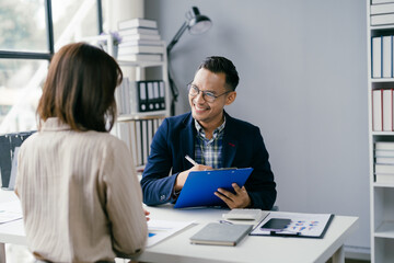 Business Meeting in Modern Office with Smiling Professional Holding Clipboard and Discussing Documents