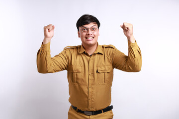 Fototapeta premium Excited male worker wearing brown uniform raised his arm. pegawai negeri sipil indonesian government employees