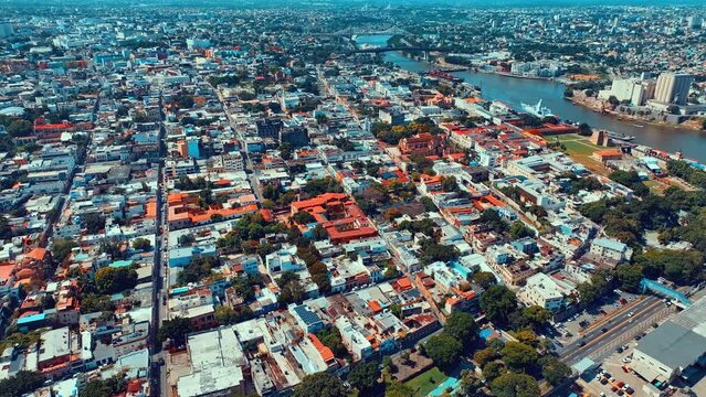 Metropolitan cityscape of an old residential area with apartment buildings. Tropical natural landscape in the Dominican city. Aerial view of the houses. Summer city landscape from a bird's eye view.