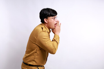 Indonesian government employees yelling loudly to copy space on the side, with hand next to mouth