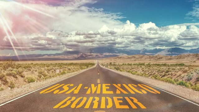 A road and sign on the border between USA and Mexico
