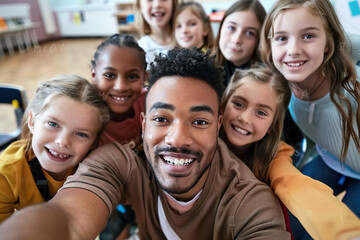 African-American teacher holds camera for selfie everyone is smiling, positive and inclusive learning environment. Diverse multiracial high school erasmus students posing with teacher in classroom. 
