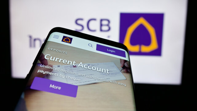 Stuttgart, Germany - 06-07-2024: Mobile phone with website of The Siam Commercial Bank Public Company Limited (SCB) in front of business logo. Focus on top-left of phone display.
