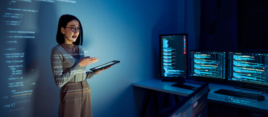 asian woman programmer standing in front of a screen with code projected  presentation the...