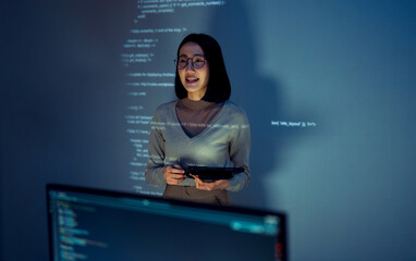 asian woman programmer standing in front of a screen with code projected  presentation the...