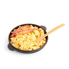 Frying pan of tasty scrambled eggs with bacon on white background