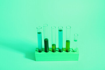 Test tubes with different samples in wooden stand on colorful background