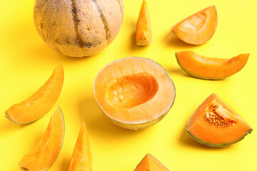 Pieces of sweet melon on yellow background
