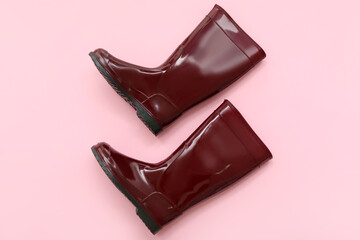 Red gumboots on pink background