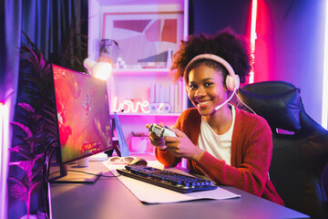 African American girl gaming streamer team winner playing online fighting with Esport wearing...