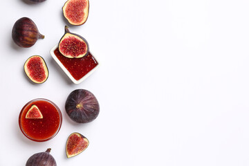 Bowls of sweet fig jam on white background