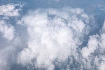 Cloudscape developing in gorgeous form. View from airplane window. Scenic sky view from above