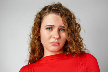 Young Woman With Curly Hair Expressing Concern