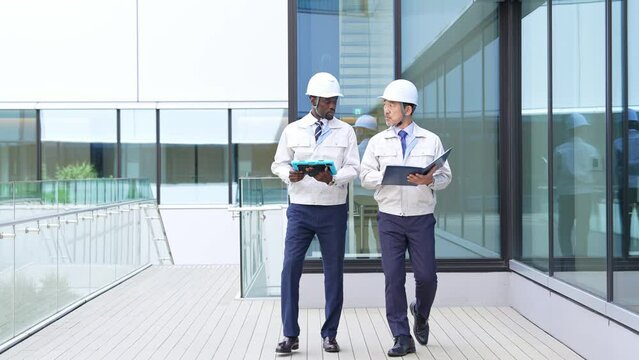 Group of multinational engineers walking through a building