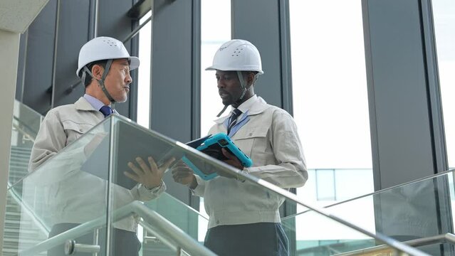 Group of multinational engineers having a conversation in a building