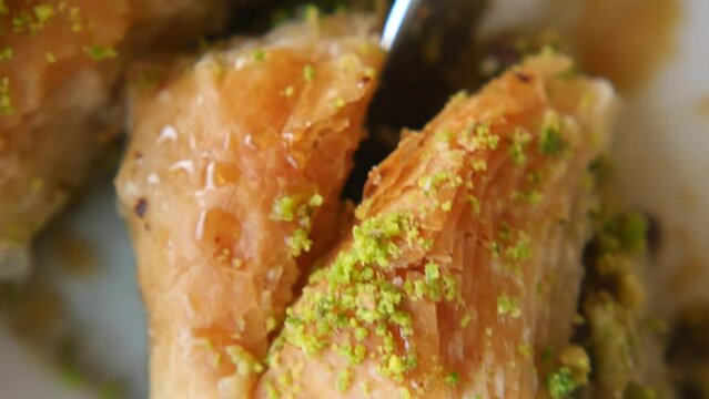 Closeup of cutting turkish dessert baklava with a knife 