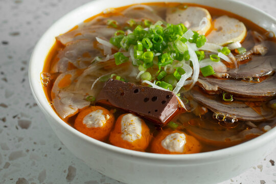 A view of a bowl of bun bo hue.