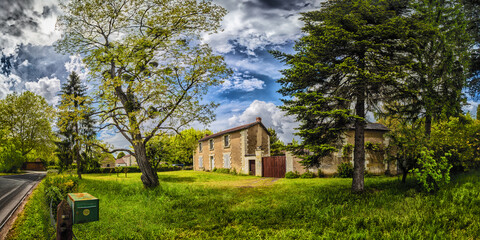 Rural Farmhouse Under Cloudy Skies