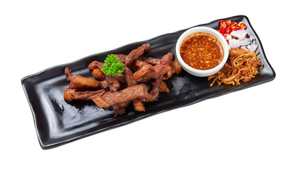 Top view of Deep Fried Sun-Dried Beef with Cayenne Chili Sauce Thai style on black plate isolated on white background.