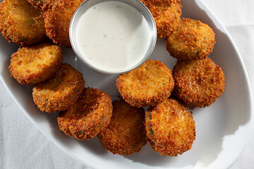 A top down view of a plate of deep fried zucchini.