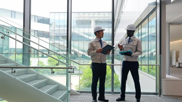 Group of multinational engineers having a conversation in a building