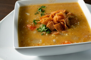 A closeup view of a bowl of lentil soup.
