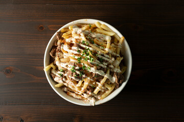A top down view of a bowl of beef shawarma fries.