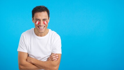 Man standing with peruvian flag painted on face smiling