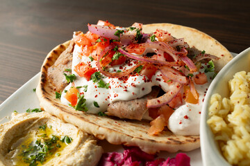 A closeup view of a beef gyro plate.