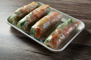 A view of a tray of tofu spring rolls.