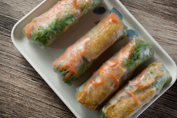 A top down view of a tray of tofu spring rolls.