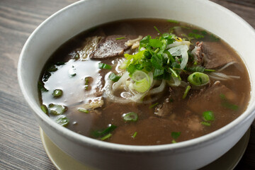 A closeup view of a bowl of brisket pho.