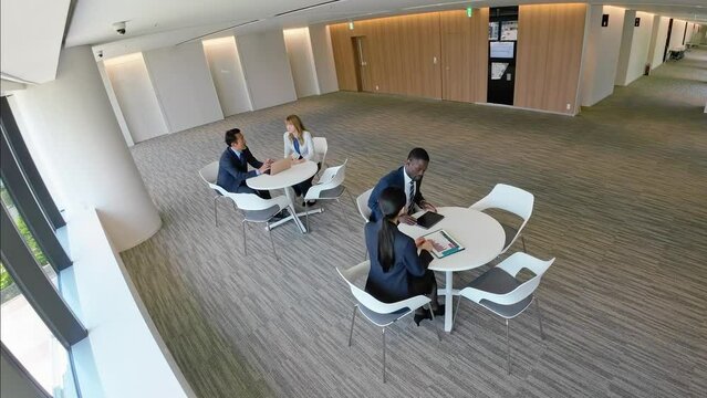 Aerial view of people in a meeting in the lobby from a surveillance camera