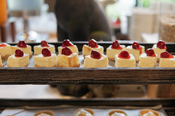 Mini cheesecakes with strawberries on top.