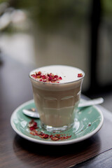 Rose milk tea topped with a fresh rose petal
