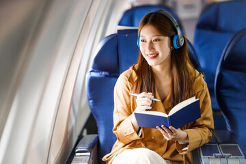 A young Asian woman, a passenger on an airplane, embarks on an educational journey abroad, representing cultural exchange and academic experiences in global travel and transportation.