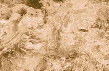 Abstract marble background of different shades of ocher. Gray and brown specks of impregnation. Colors randomly intersect and mix. Different textures. Pastel colors.