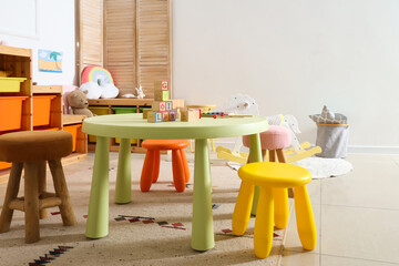 Interior of light playroom with toys in kindergarten