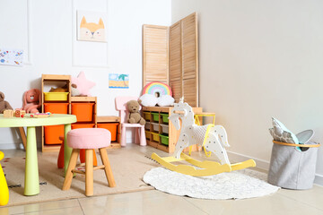 Interior of light playroom with toys in kindergarten