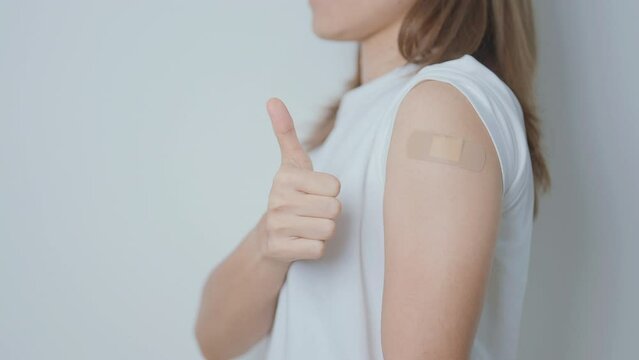 Woman with bandage after receiving vaccine. Vaccination and Immunization for Influenza, HPV, Zoster, IPD, DTP or Diphtheria, Tetanus and Pertussis, MMR, Hepatitis B, Covid  and Varicella vaccine