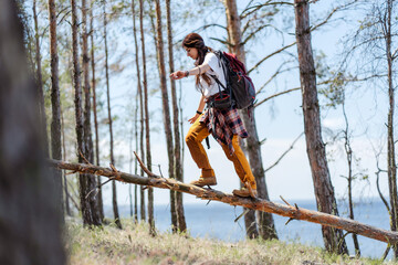 Hiking, smile and woods with woman walking in nature or the wilderness for adventure