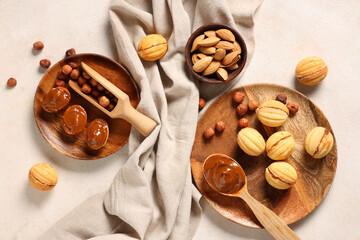 Tasty walnut shaped cookies with boiled condensed milk and hazelnuts on white grunge table
