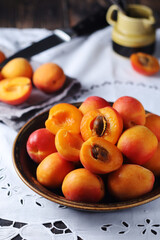 Fresh ripe apricots in bowl in rustic style