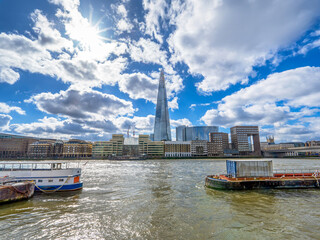 View of London's River Thames with the Shard skyscraper in the background backlit with lens flare...