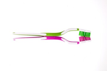 Closeup of two toothbrushes isolated on white background.